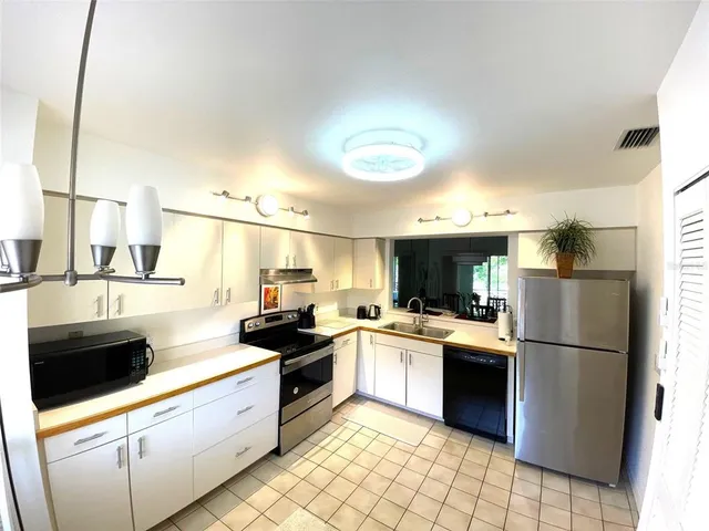 a kitchen with a sink a refrigerator and a stove