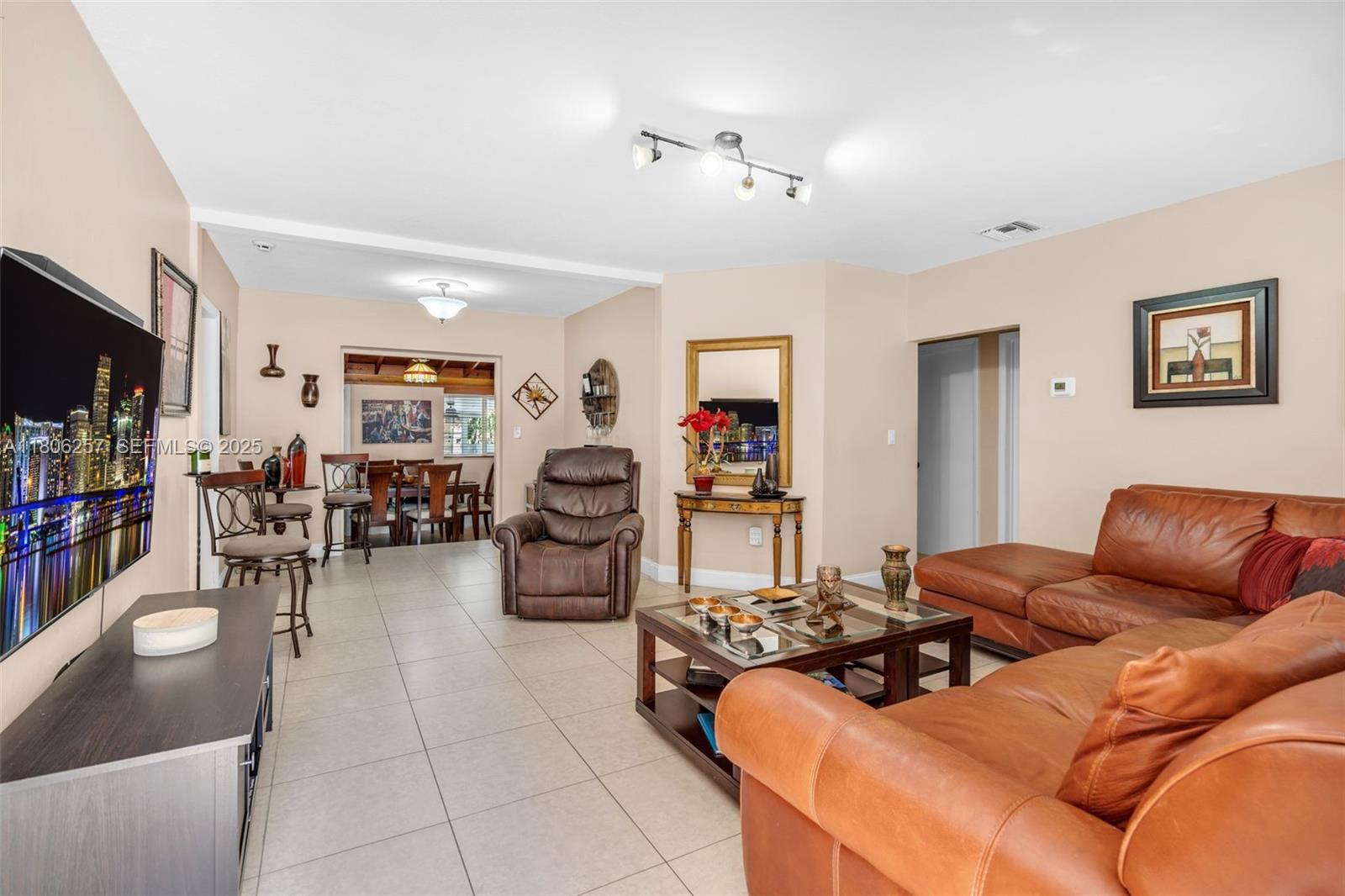 1901 Southwest 37th Avenue Miami, FL 33145 - Photo 6 of 35 a living room with furniture and a flat screen tv