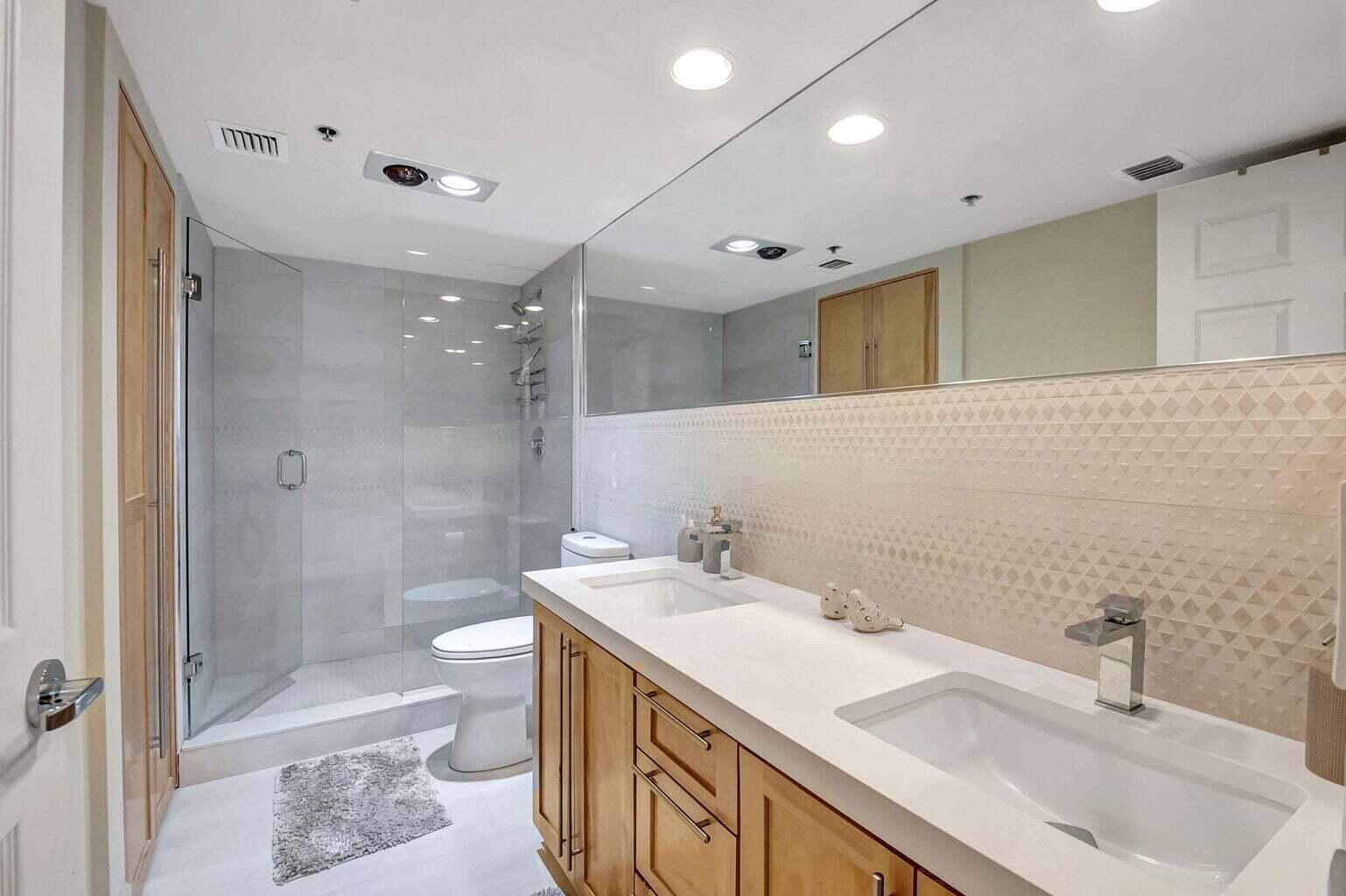 2707 North Ocean Boulevard, Unit D205 Boca Raton, FL 33431 - Photo 26 of 51 a bathroom with a sink a toilet and shower