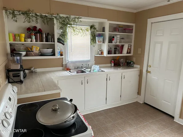 a room with a sink and a washer dryer