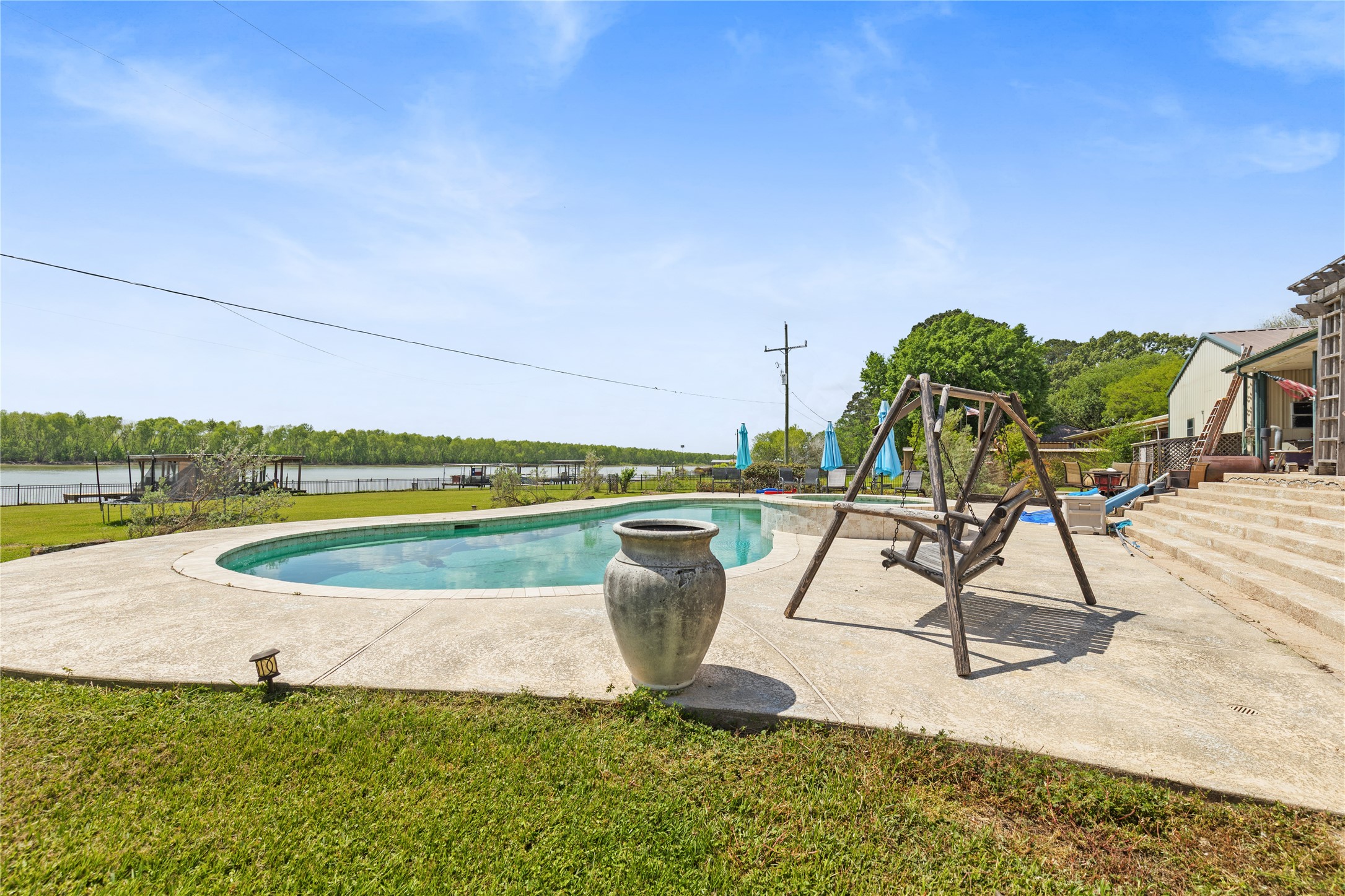 174 Lake Front Drive Trinity, TX 75862 - Photo 32 of 44 a view of a swimming pool with a patio