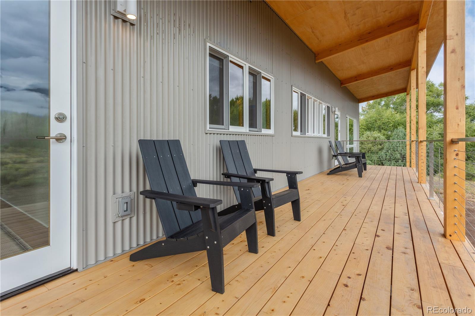1276 Sycamore Road Crestone, CO 81131 - Photo 15 of 48 a balcony with furniture and wooden floor