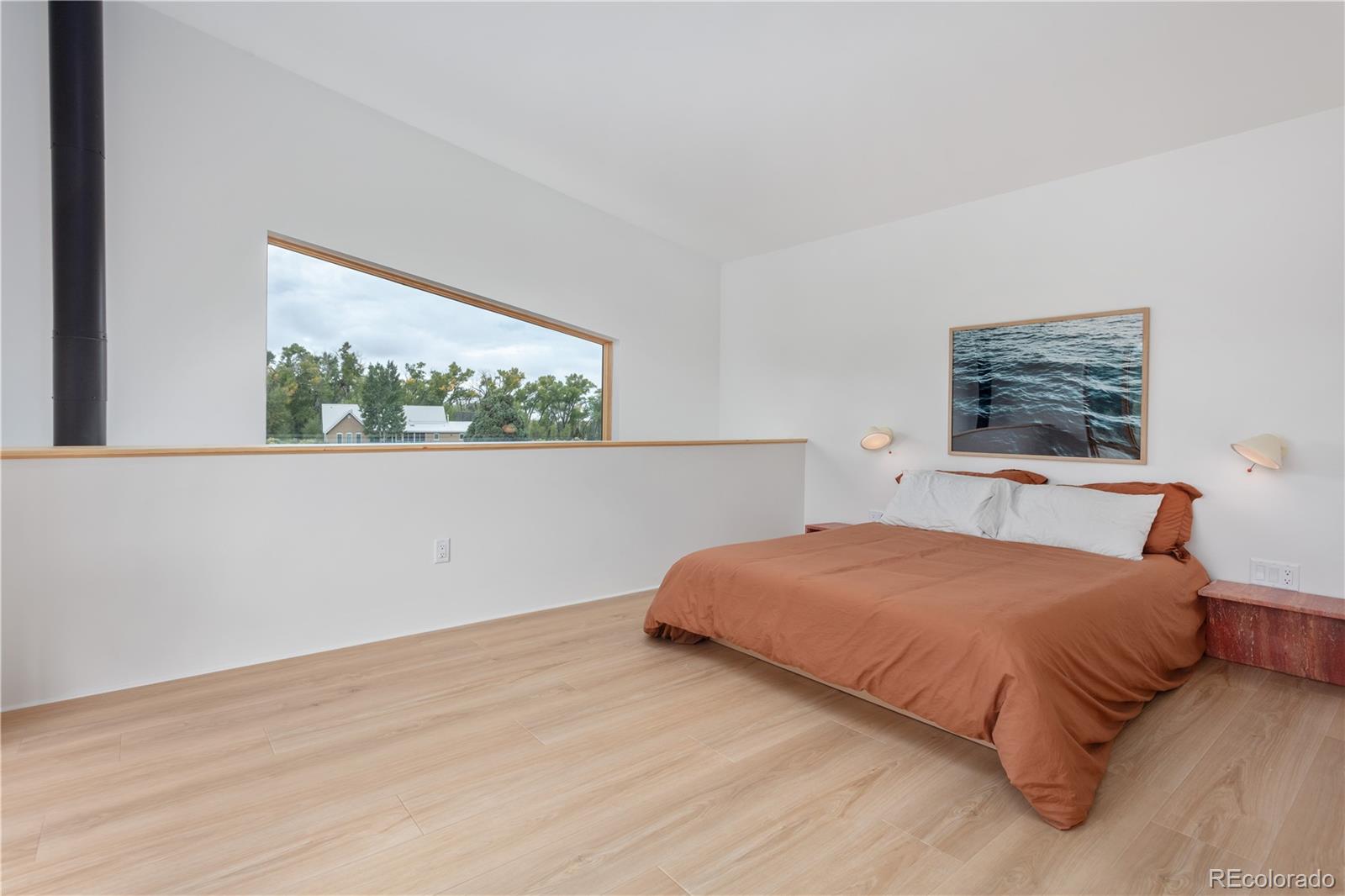 1276 Sycamore Road Crestone, CO 81131 - Photo 18 of 48 a bedroom with a bed and a large window