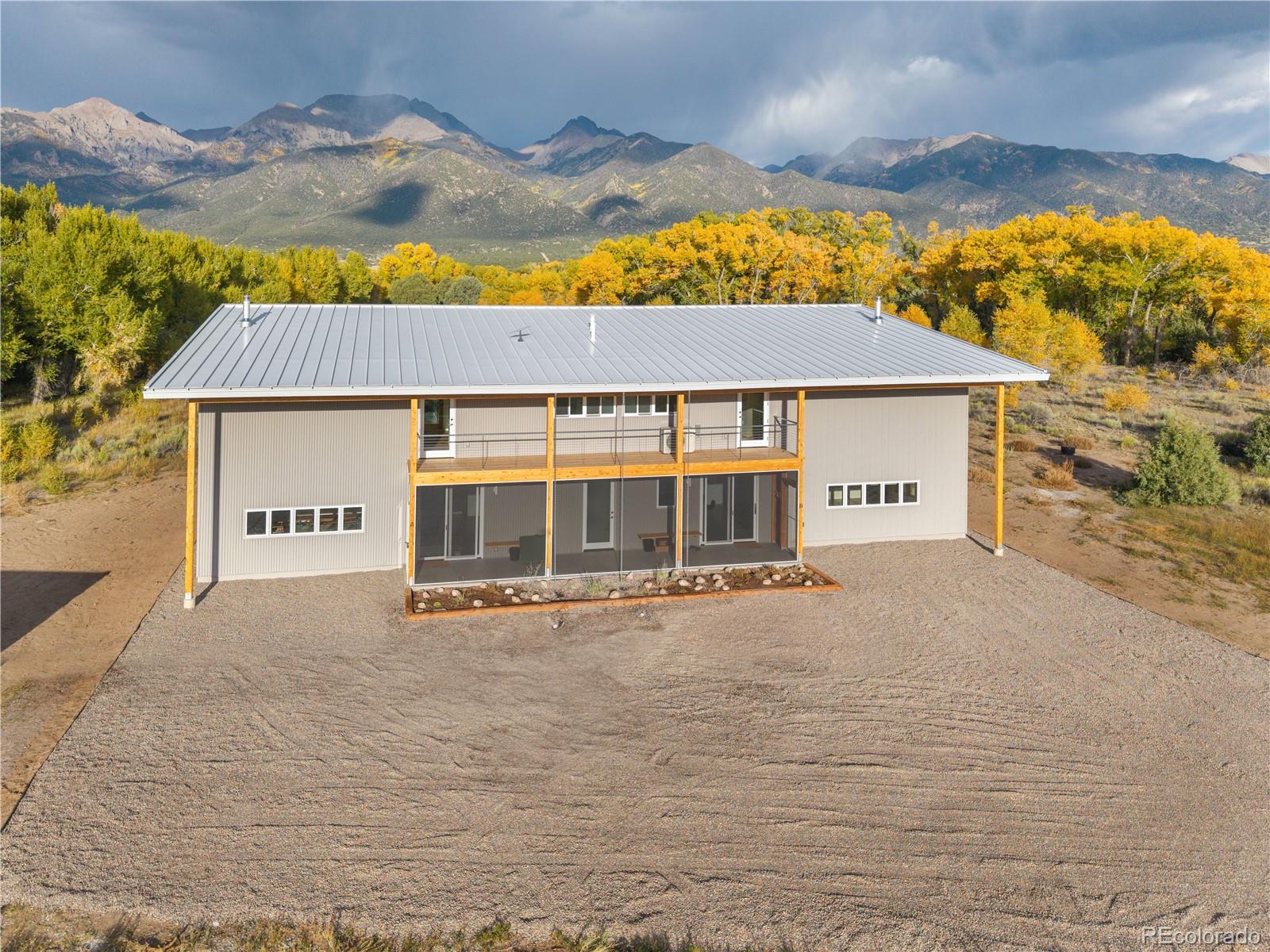1276 Sycamore Road Crestone, CO 81131 - Photo 22 of 48 a view of a house with a yard and potted plants