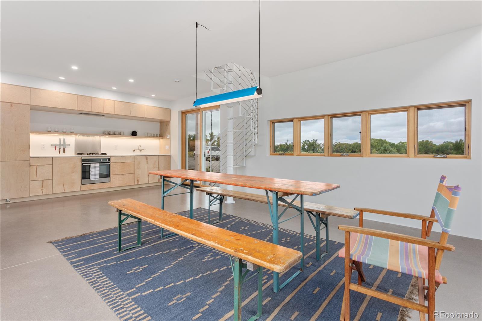 1276 Sycamore Road Crestone, CO 81131 - Photo 28 of 48 a living room with a table chairs and a wooden floor