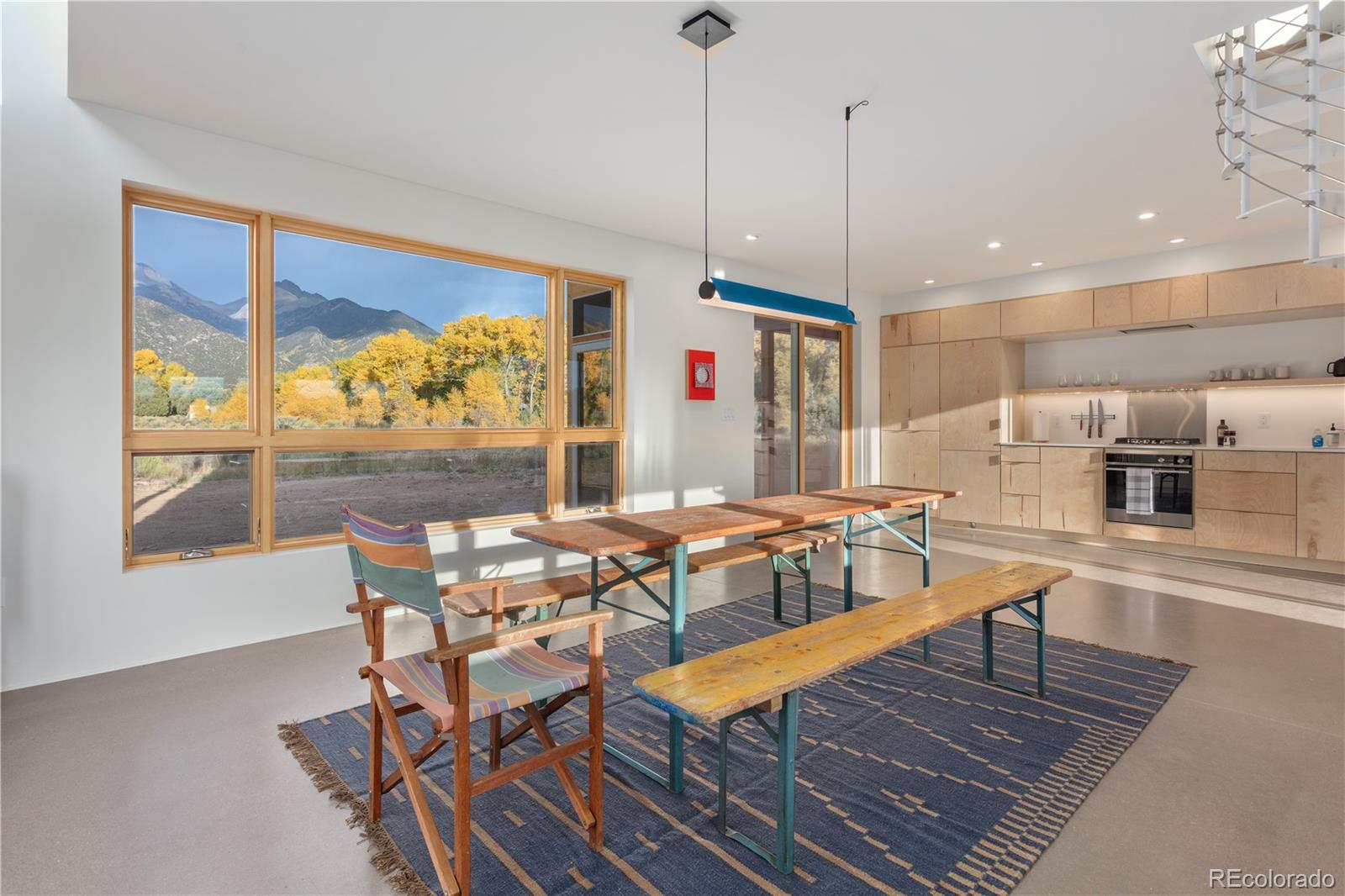 1276 Sycamore Road Crestone, CO 81131 - Photo 30 of 48 a dining area with furniture a rug and wooden floor