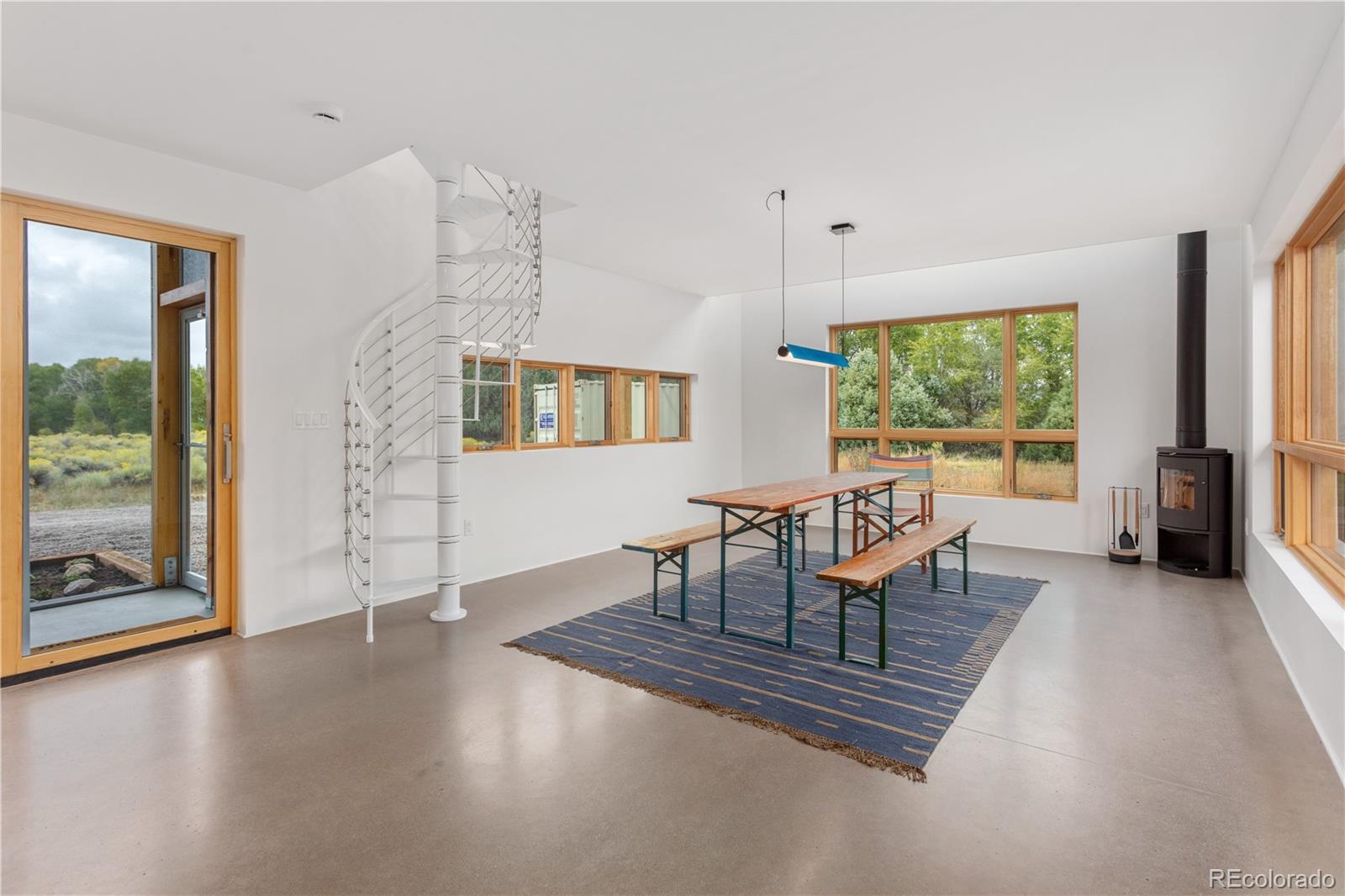 1276 Sycamore Road Crestone, CO 81131 - Photo 34 of 48 a living room with furniture large window and flat screen tv