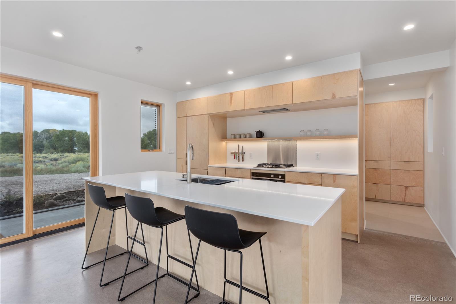 1276 Sycamore Road Crestone, CO 81131 - Photo 4 of 48 a kitchen with a counter space a sink cabinets and appliances