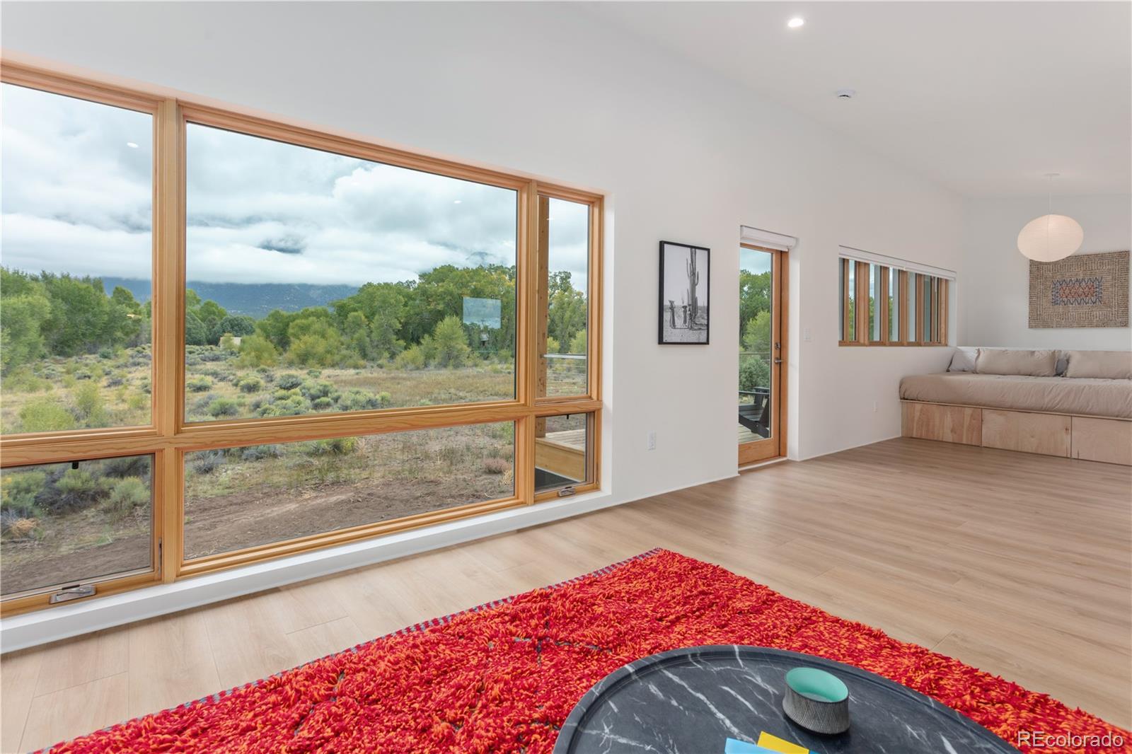 1276 Sycamore Road Crestone, CO 81131 - Photo 42 of 48 a bedroom with a bed and a large window with outer view