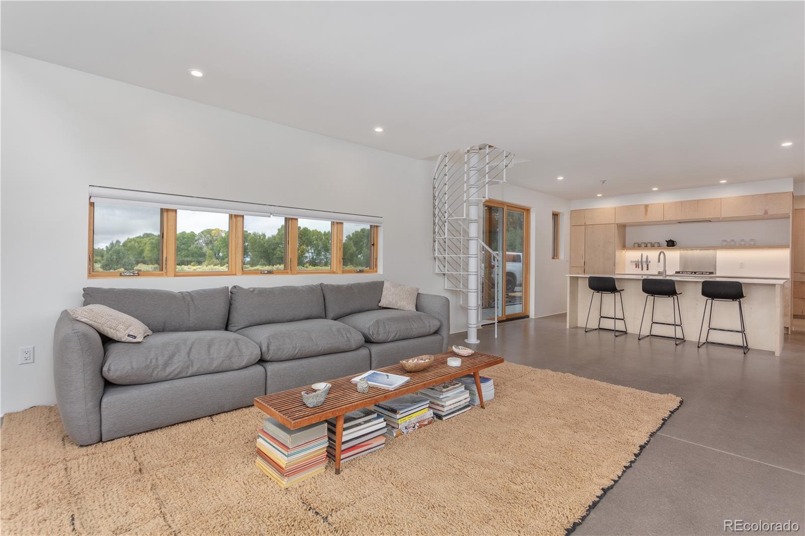 1276 Sycamore Road Crestone, CO 81131 - Photo 7 of 48 a living room with furniture and a large window