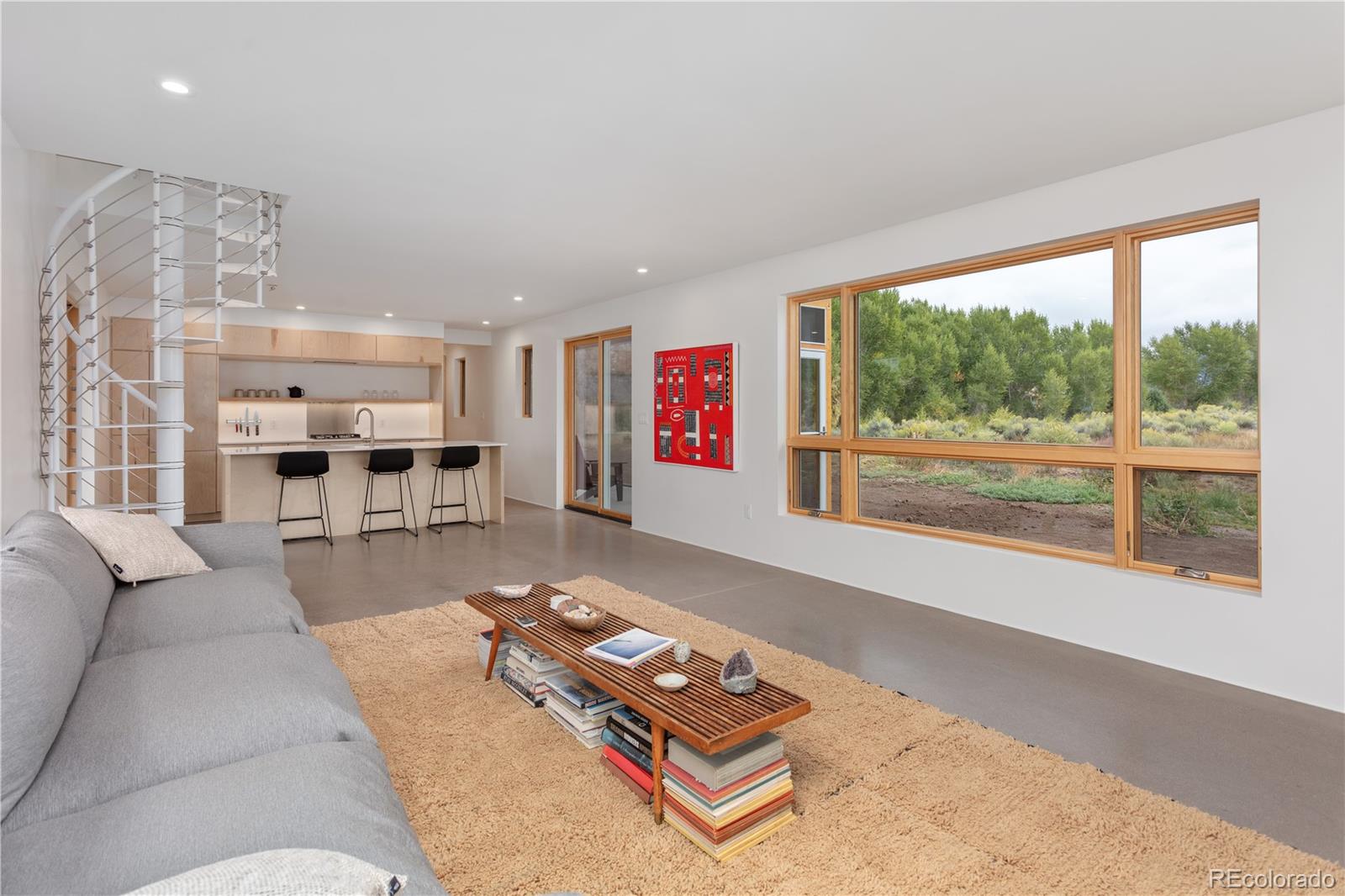 1276 Sycamore Road Crestone, CO 81131 - Photo 8 of 48 a living room with furniture and a large window