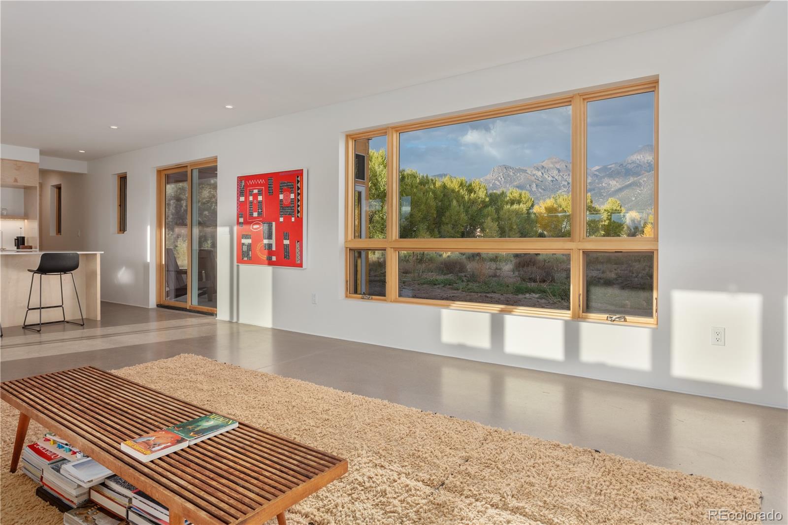 1276 Sycamore Road Crestone, CO 81131 - Photo 9 of 48 a living room with furniture and a large window