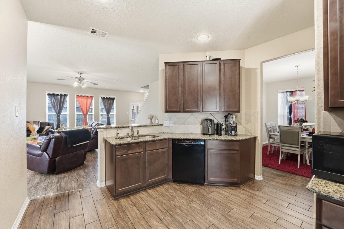 14706 Ruddy Duck Lane Houston, TX 77049 - Photo 11 of 32 a kitchen with stainless steel appliances granite countertop a sink dishwasher stove and oven with wooden floor