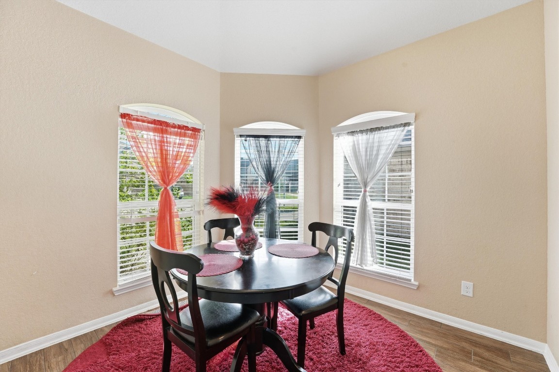 14706 Ruddy Duck Lane Houston, TX 77049 - Photo 12 of 32 a view of a dining room with furniture and wooden floor