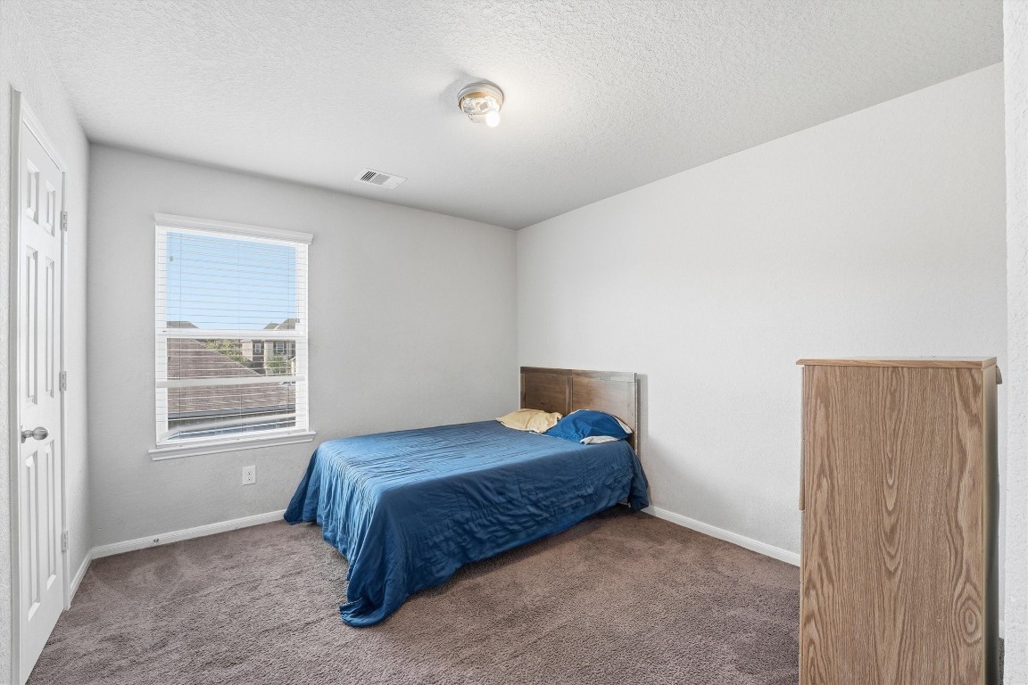 14706 Ruddy Duck Lane Houston, TX 77049 - Photo 16 of 32 a bedroom with a bed and a window