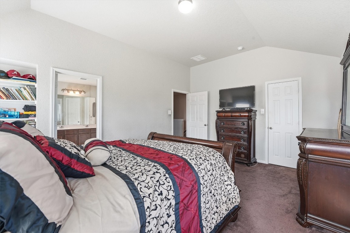 14706 Ruddy Duck Lane Houston, TX 77049 - Photo 20 of 32 a bedroom with a bed and a television