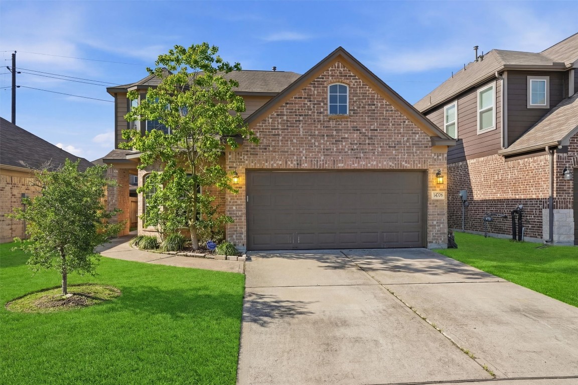 14706 Ruddy Duck Lane Houston, TX 77049 - Photo 2 of 32 a front view of a house with a garden and plants