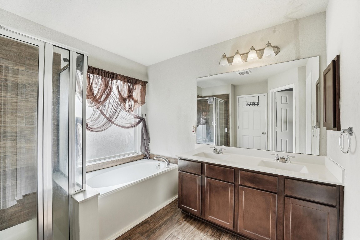 14706 Ruddy Duck Lane Houston, TX 77049 - Photo 22 of 32 a bathroom with a double vanity sink mirror and bathtub