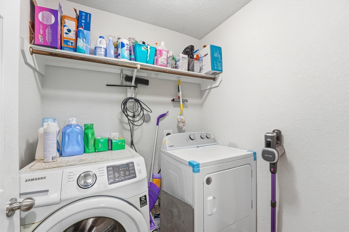 14706 Ruddy Duck Lane Houston, TX 77049 - Photo 24 of 32 a view of storage and utility room with washer and dryer