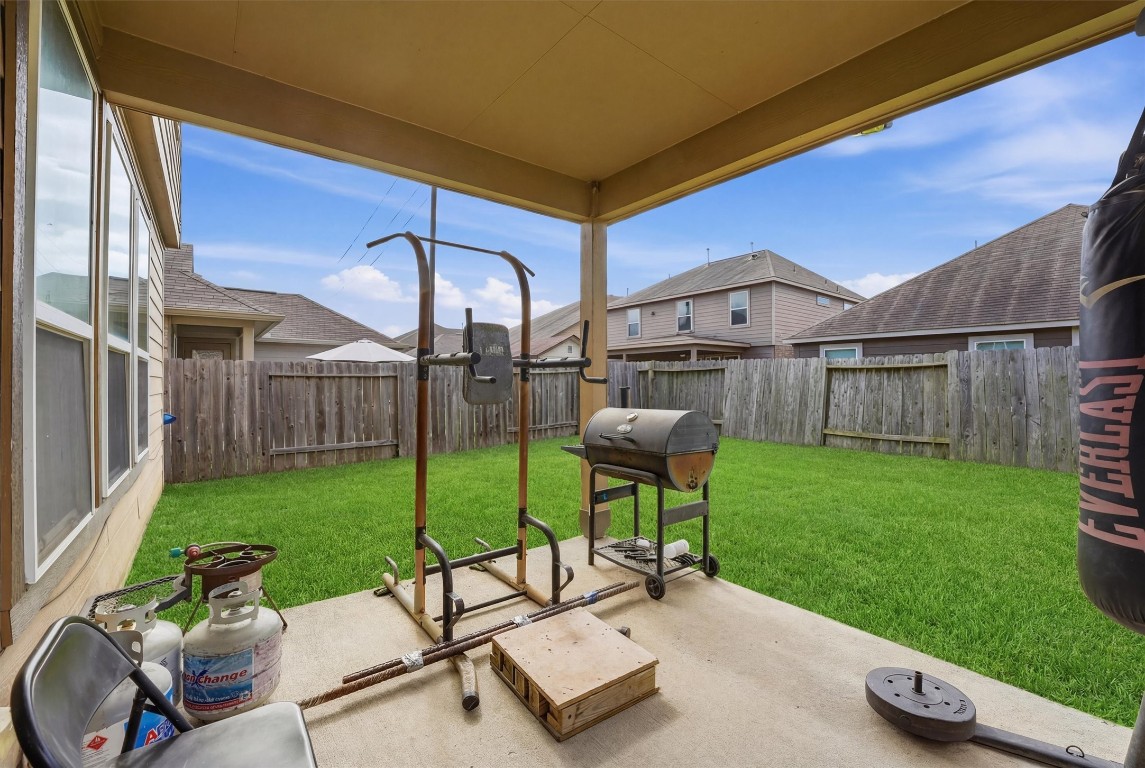 14706 Ruddy Duck Lane Houston, TX 77049 - Photo 25 of 32 a view of a chairs and table in patio with a yard