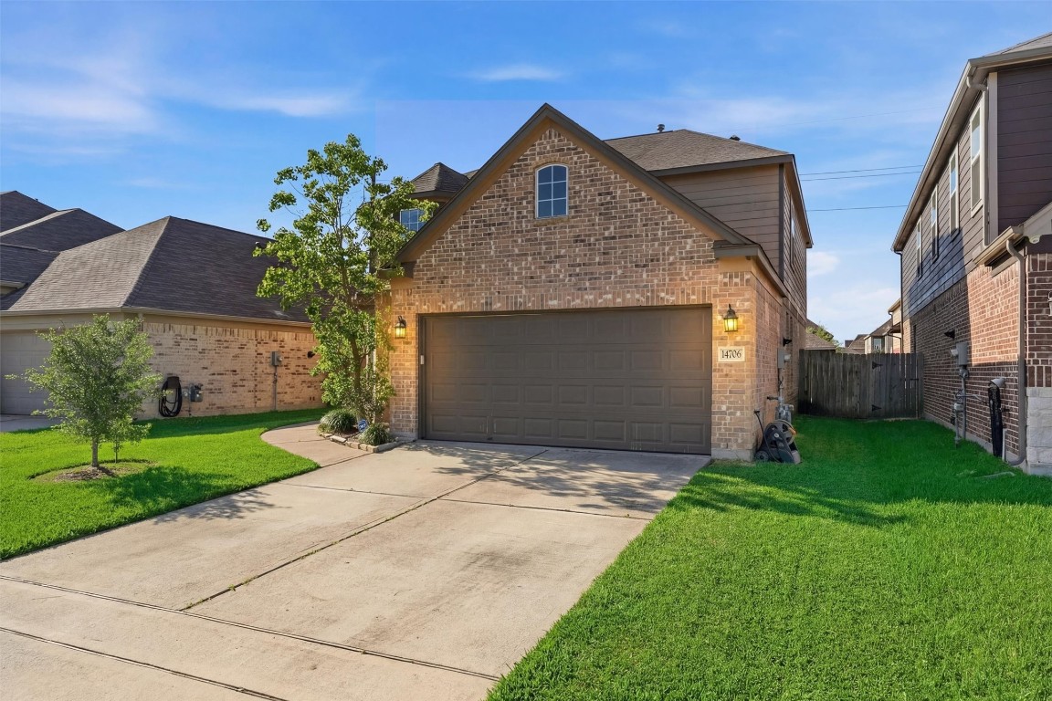 14706 Ruddy Duck Lane Houston, TX 77049 - Photo 3 of 32 a front view of a house with a yard and garage