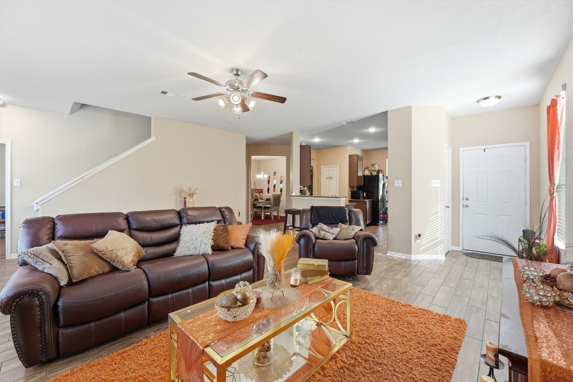14706 Ruddy Duck Lane Houston, TX 77049 - Photo 8 of 32 a living room with furniture a wooden floor and a chandelier