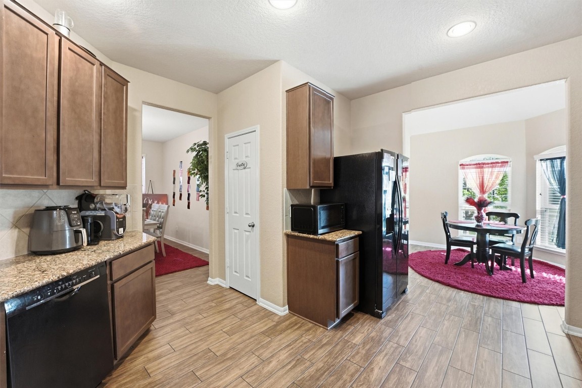 14706 Ruddy Duck Lane Houston, TX 77049 - Photo 9 of 32 a kitchen with stainless steel appliances granite countertop a refrigerator stove top oven and sink