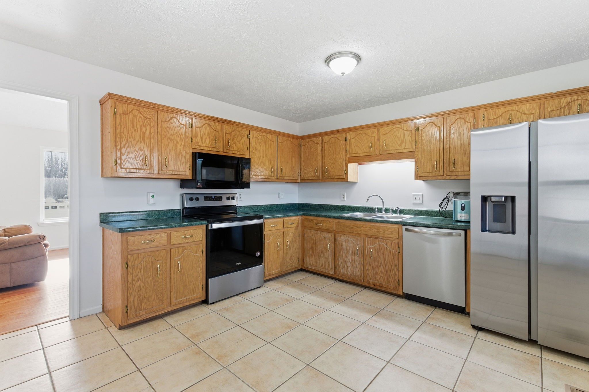 2103 Halligen Court Murfreesboro, TN 37127 - Photo 9 of 16 a kitchen with granite countertop a refrigerator and a stove top oven
