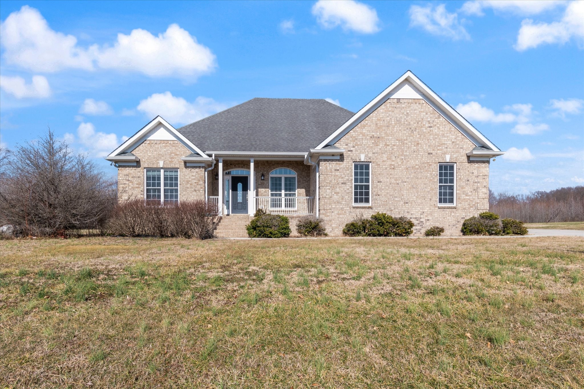 5087 Asbury Road Manchester, TN 37355 - Photo 1 of 33 a front view of a house with a yard