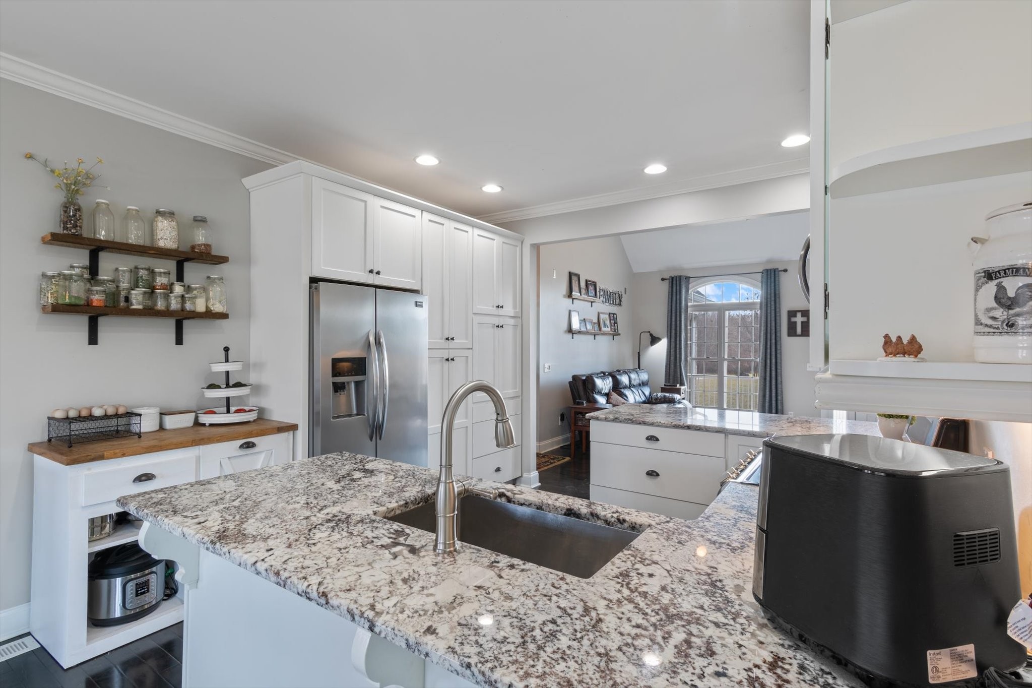 5087 Asbury Road Manchester, TN 37355 - Photo 21 of 33 a kitchen with stainless steel appliances granite countertop a sink stove and refrigerator