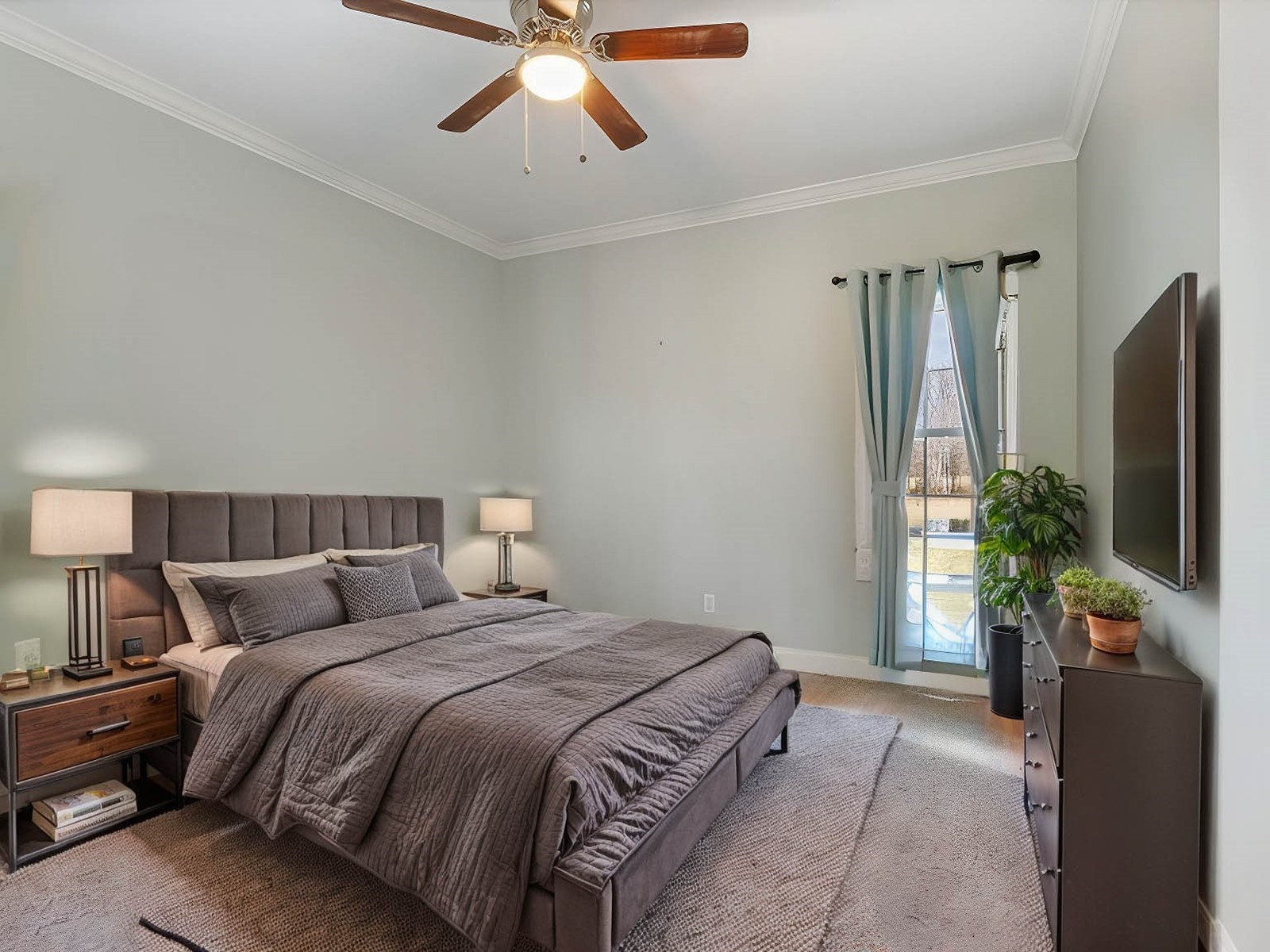 5087 Asbury Road Manchester, TN 37355 - Photo 30 of 33 a bedroom with a large bed and a flat tv screen on a dresser