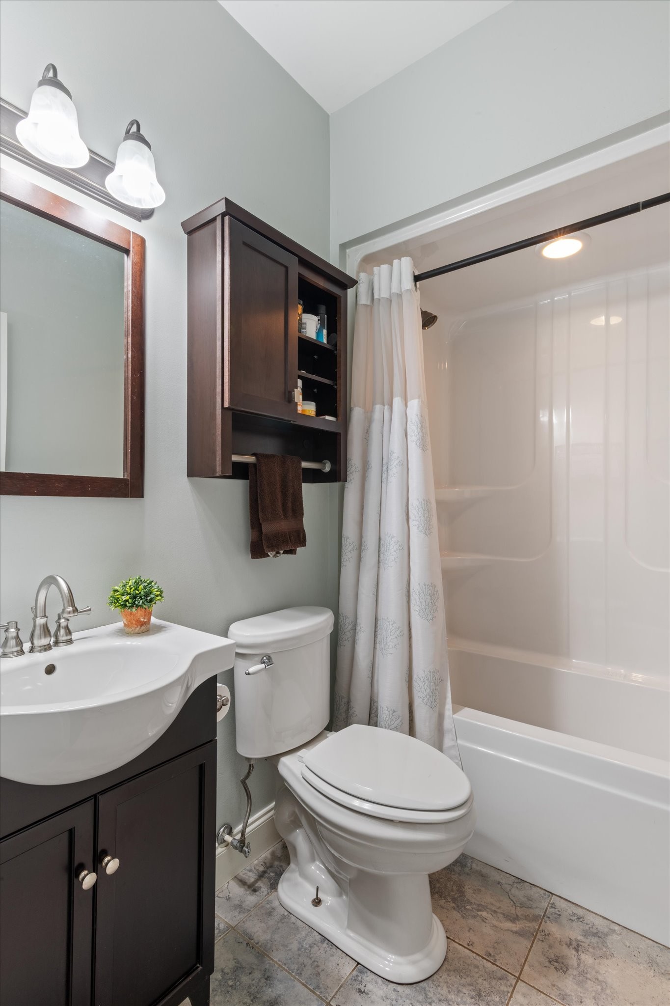 5087 Asbury Road Manchester, TN 37355 - Photo 32 of 33 a bathroom with a sink a toilet a mirror a bathtub and shower