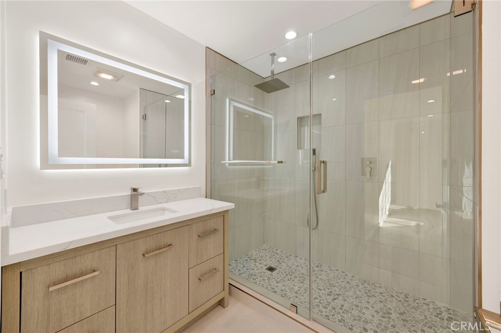 7118 Apperson Street Tujunga, CA 91042 - Photo 12 of 25 a bathroom with a shower sink and mirror