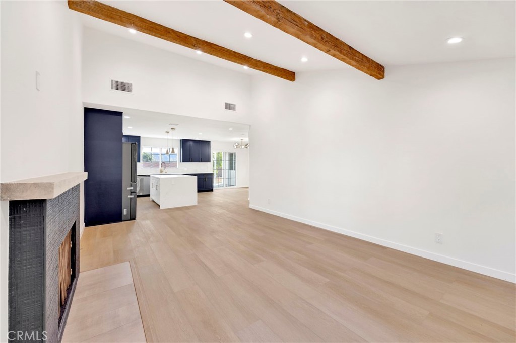 7118 Apperson Street Tujunga, CA 91042 - Photo 6 of 25 a view of a kitchen with wooden floor and a fireplace