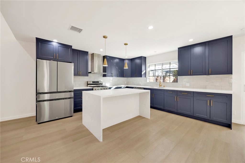 7118 Apperson Street Tujunga, CA 91042 - Photo 8 of 25 a kitchen with a refrigerator sink and cabinets