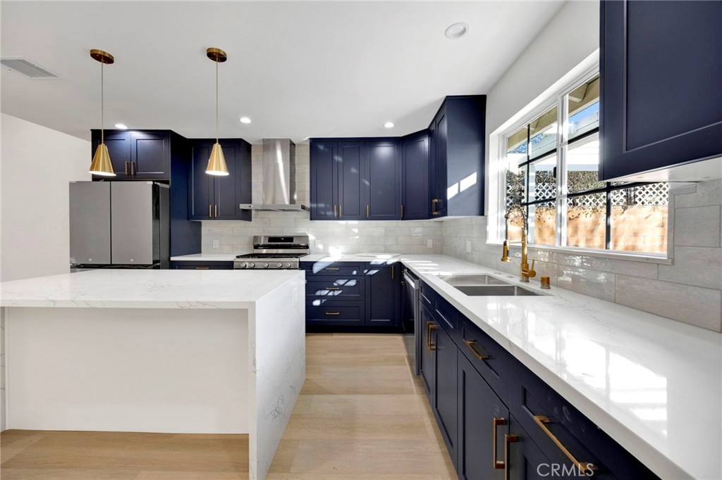 7118 Apperson Street Tujunga, CA 91042 - Photo 9 of 25 a kitchen with a sink stove and refrigerator
