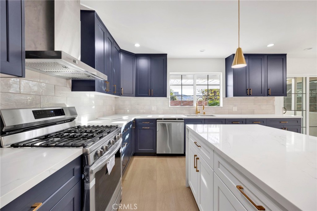 7118 Apperson Street Tujunga, CA 91042 - Photo 10 of 25 a kitchen with stainless steel appliances a sink stove and cabinets