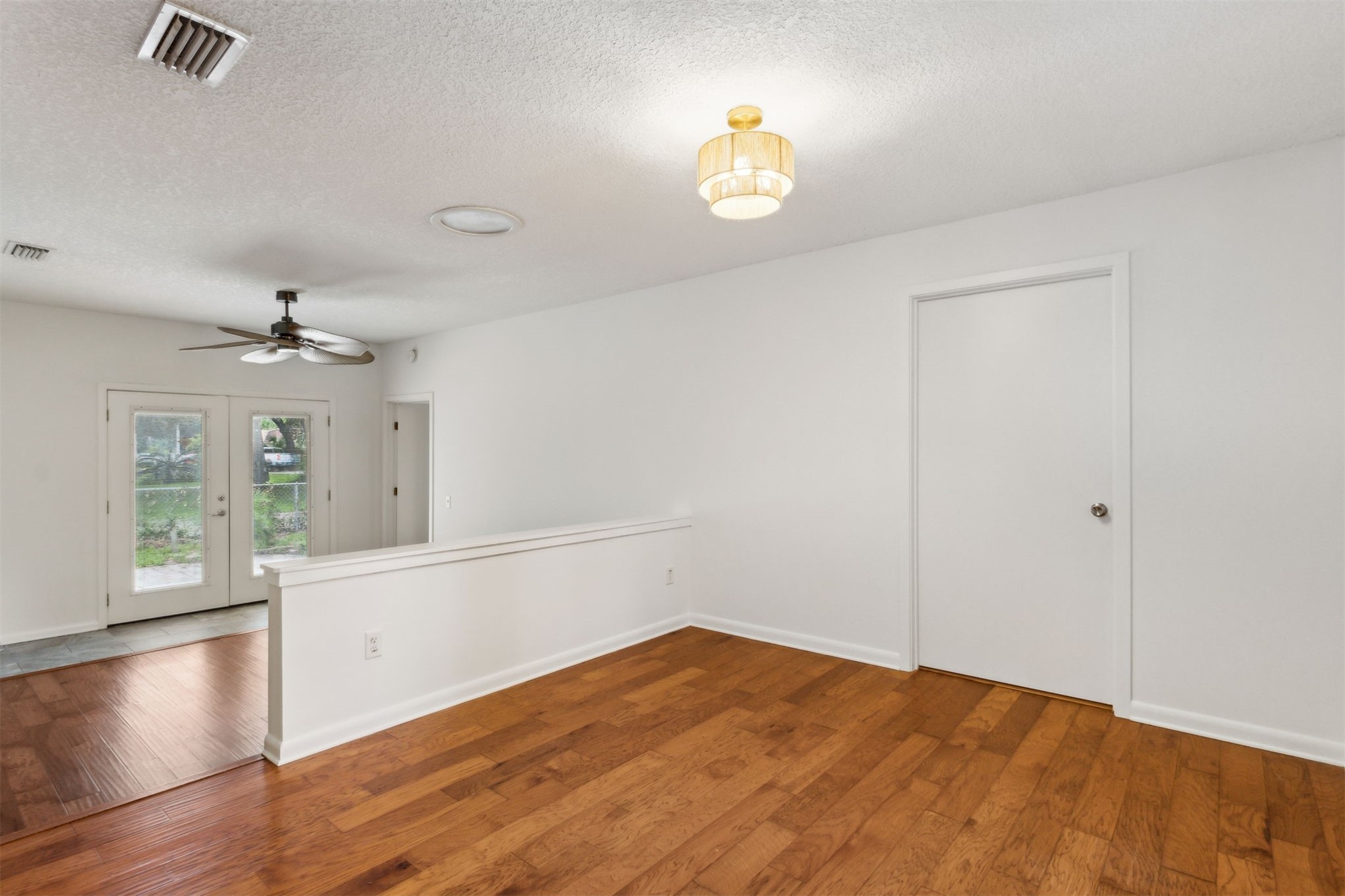 2441 Amelia Road Fernandina Beach, FL 32034 - Photo 19 of 36 a view of an empty room with window and wooden floor