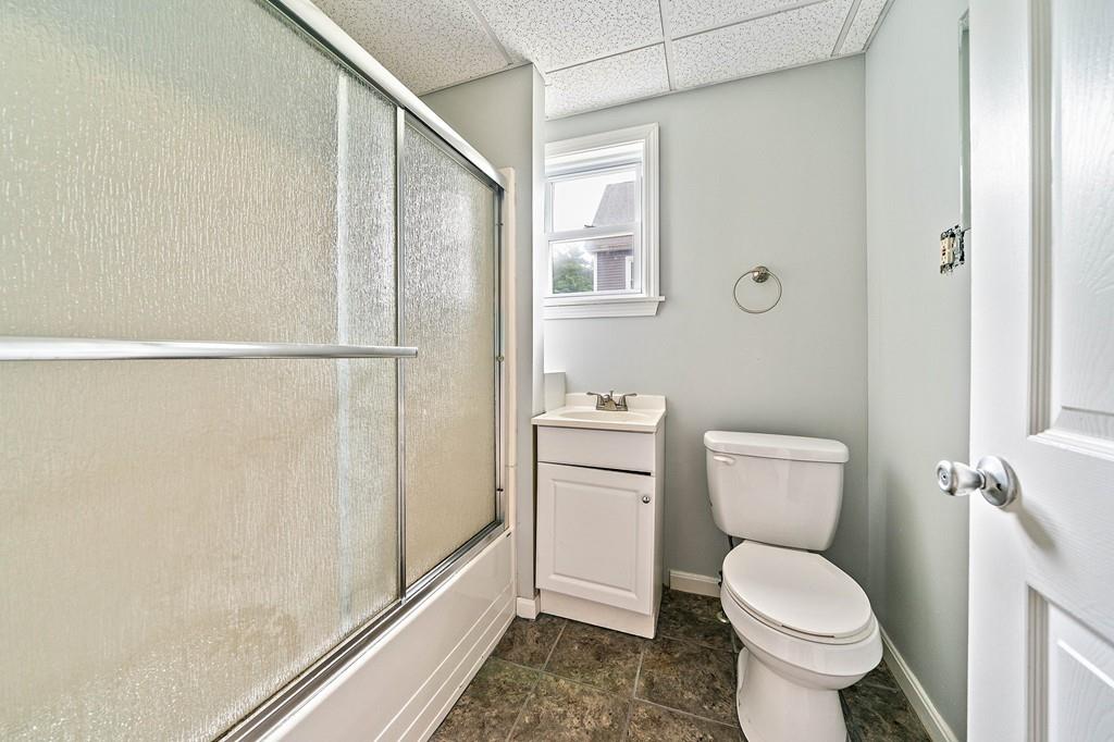12 Madison Street Taunton, MA 02780 - Photo 13 of 23 a white toilet sitting next to a bathroom sink