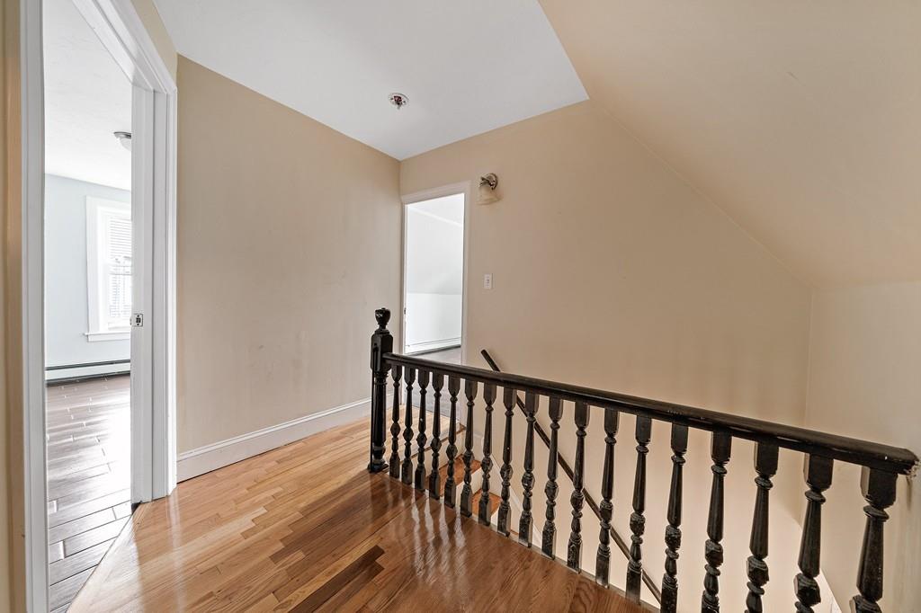 12 Madison Street Taunton, MA 02780 - Photo 15 of 23 a view of a hallway with wooden floor and a bathroom