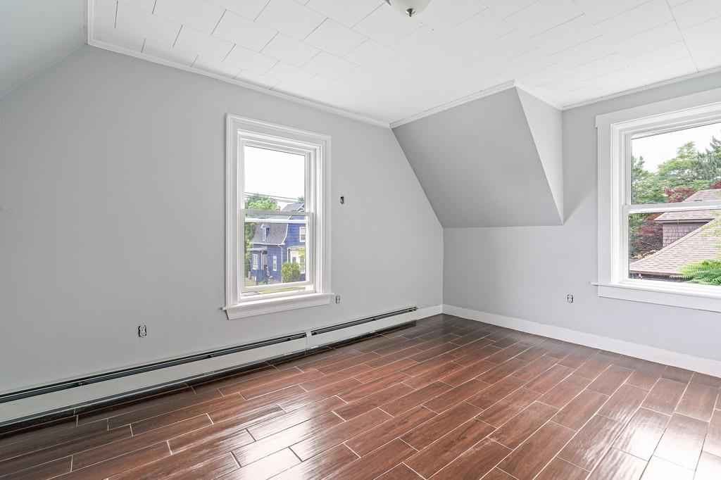 12 Madison Street Taunton, MA 02780 - Photo 17 of 23 an empty room with wooden floor and windows