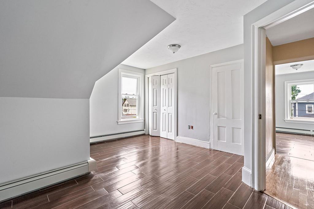 12 Madison Street Taunton, MA 02780 - Photo 18 of 23 a view of an empty room with window and wooden floor