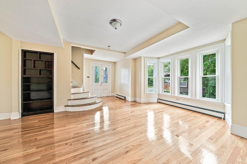 12 Madison Street Taunton, MA 02780 - Photo 4 of 23 a view of an empty room with wooden floor and windows