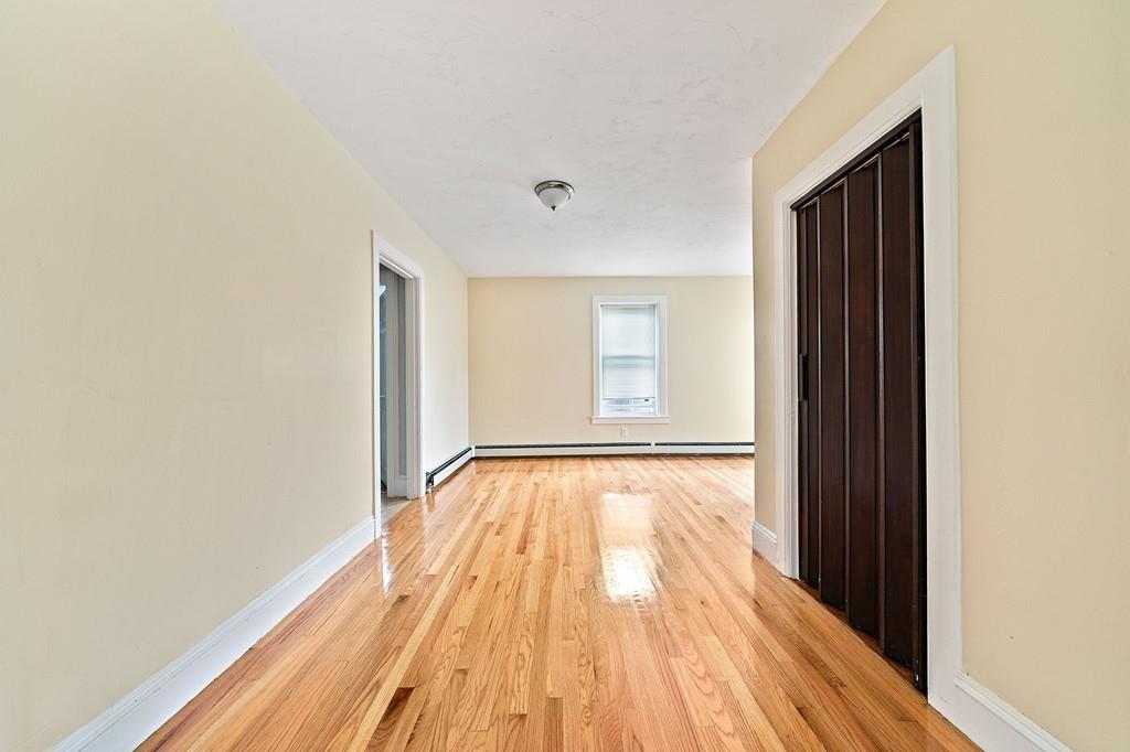12 Madison Street Taunton, MA 02780 - Photo 7 of 23 a view of an empty room with wooden floor and a window