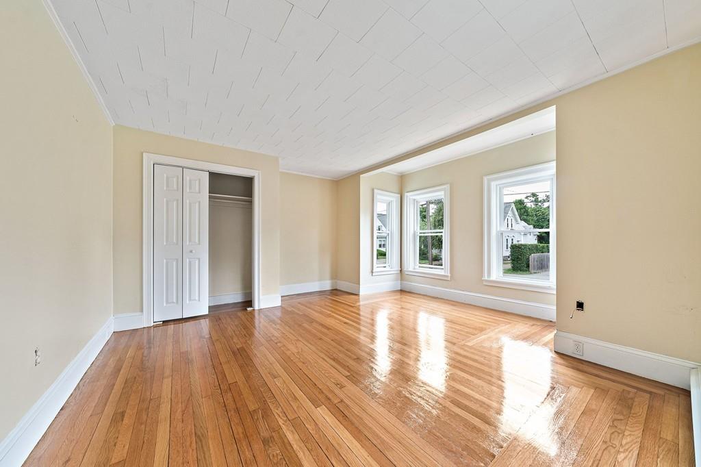 12 Madison Street Taunton, MA 02780 - Photo 8 of 23 a view of an empty room with wooden floor and a window