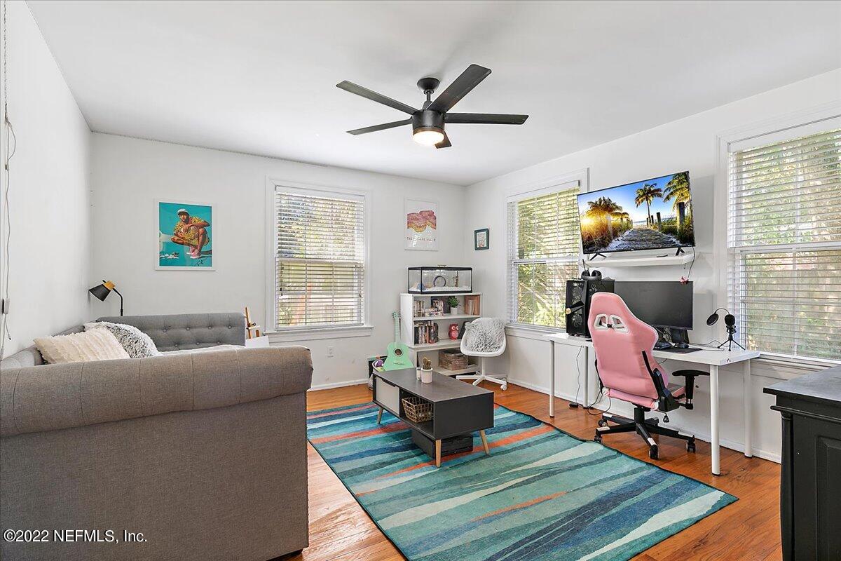1626 Brookwood Road Jacksonville, FL 32207 - Photo 13 of 27 a living room with furniture a rug and a flat screen tv