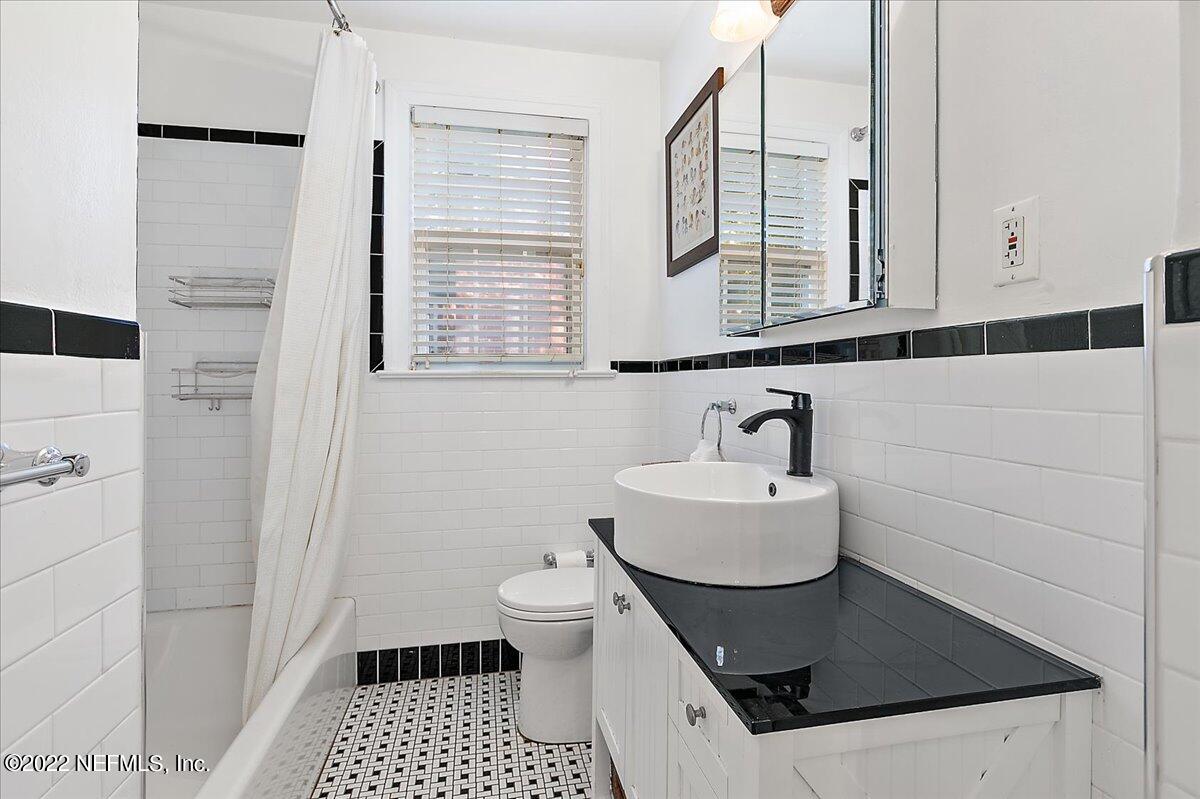 1626 Brookwood Road Jacksonville, FL 32207 - Photo 15 of 27 a bathroom with a sink and a mirror
