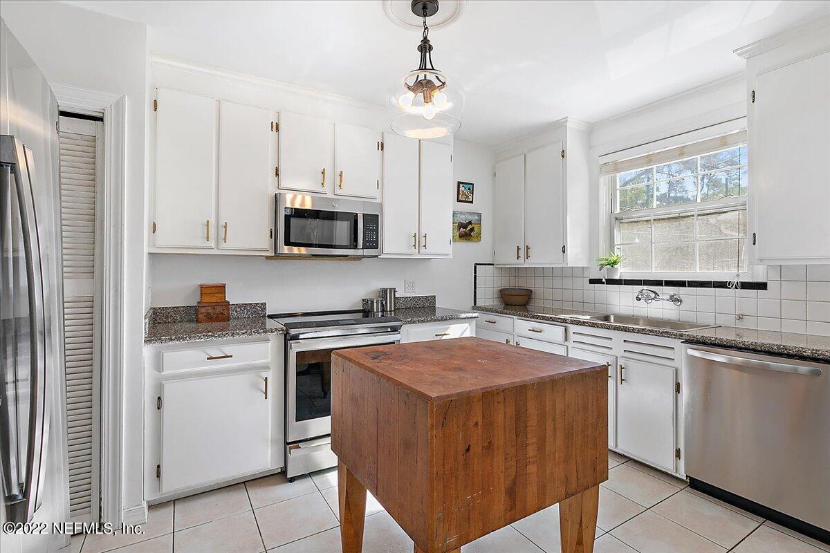 1626 Brookwood Road Jacksonville, FL 32207 - Photo 10 of 27 a kitchen with a stove top oven sink and cabinets