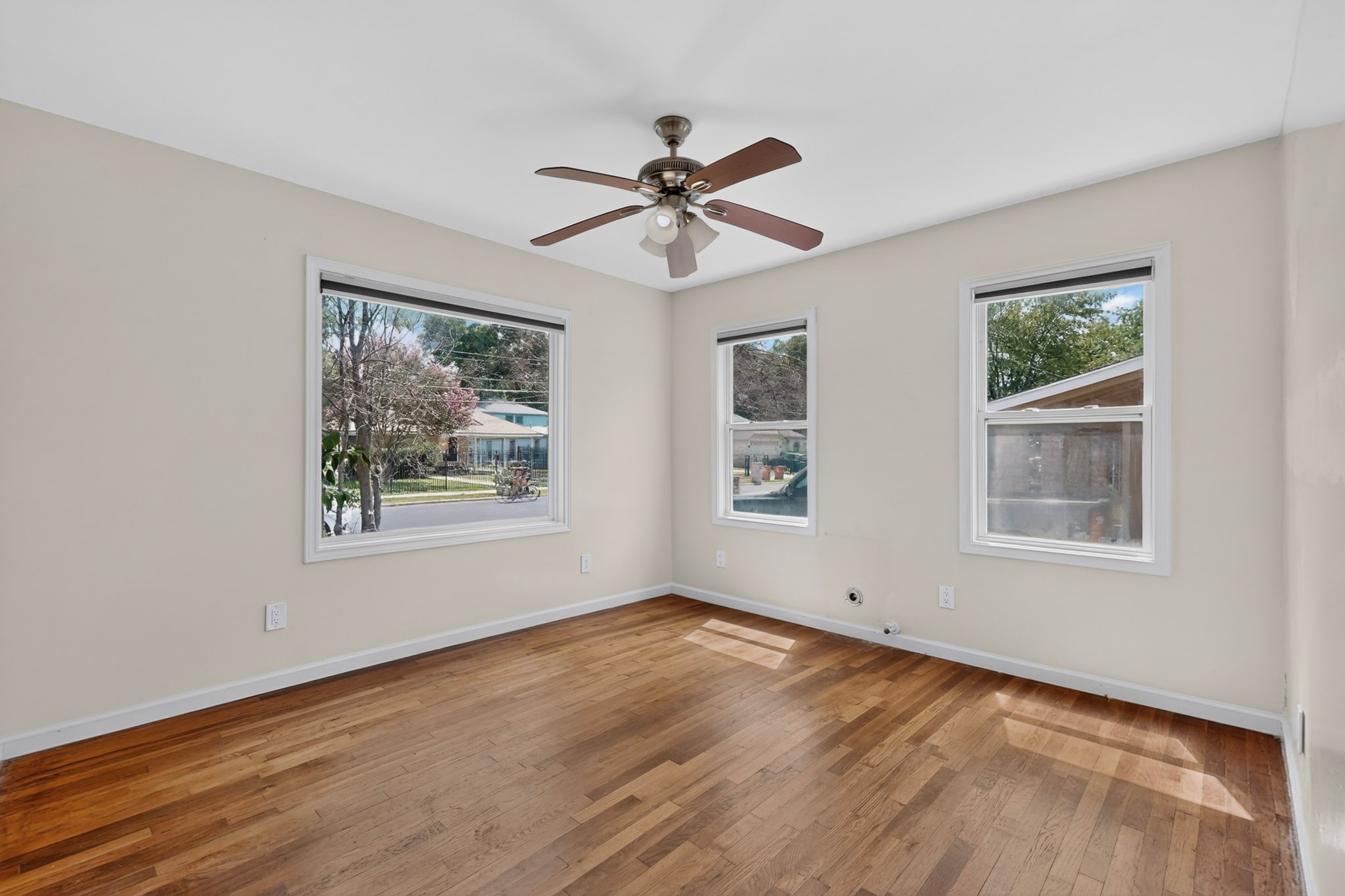 4711 Alf Avenue Austin, TX 78721 - Photo 16 of 34 BR1 - Bright hardwood floors and abundant natural light fill this inviting bedroom.