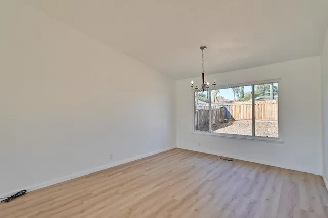 a room with window entryway and wooden floor